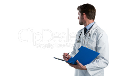 Male doctor writing on clipboard