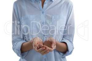 Mid-section of woman pretending to hold an invisible object