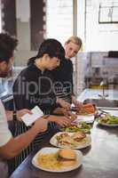 Young female chefs preparing food on kitchen counter