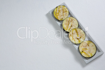 Sliced eggplants arranged in a tray