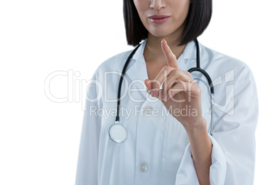 Mid section of female doctor touching invisible screen