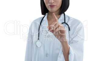 Mid section of female doctor touching invisible screen