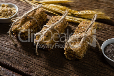 Granola bars tied with string on wooden table