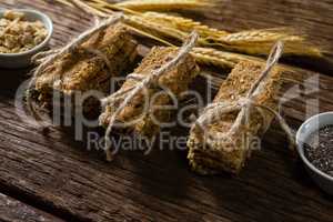Granola bars tied with string on wooden table