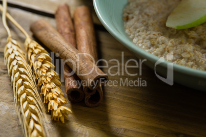 Close-up of wheat barley and cinnamon sticks