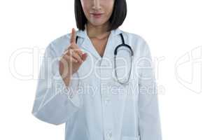 Mid section of female doctor touching invisible screen