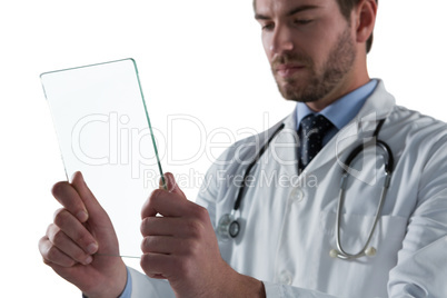 Male doctor using glass digital tablet