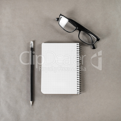 Blank notebook, glasses, pencil