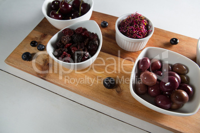 High angle view of olives with various fruits in bowls
