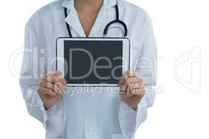 Mid section female doctor holding digital tablet
