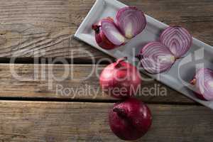 Onions in a tray on a wooden table
