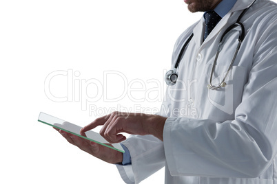 Mid-section of male doctor using glass digital tablet