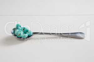 Apple jack in spoon against white background