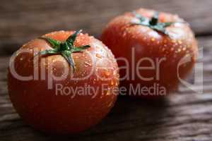Fresh wet tomatoes on wooden table
