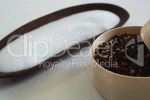 Black pepper seed and salt on white background