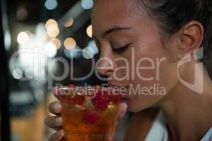 Close-up of beautiful woman having drink