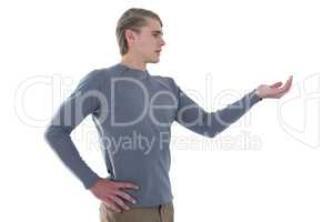 Businessman with hand on hip holding invisible product