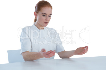 Young businesswoman examining imaginary product