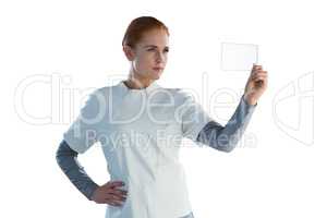 Confident businesswoman looking at glass interface