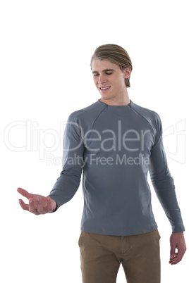Smiling businessman holding invisible product