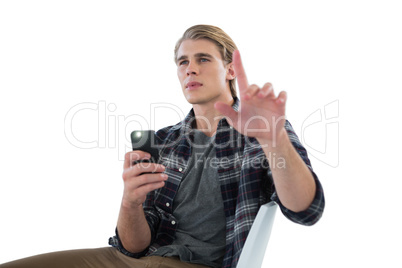 Businessman photographing while using imaginary screen