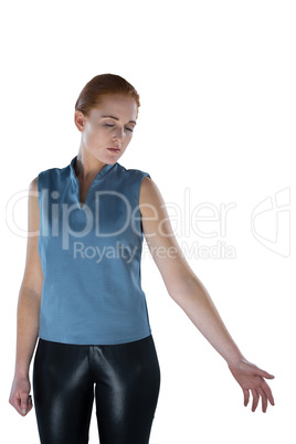 Businesswoman gesturing while standing with eyes closed