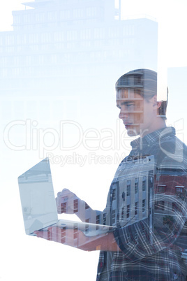 Side view of businessman using laptop reflecting on window