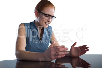 Smiling businesswoman gesturing while wearing smart glasses
