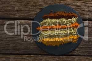 Various type of spice powder on a chopping board