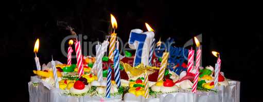 Cake with festive candles and number 7
