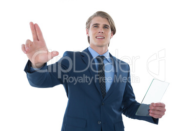 Businessman holding glass interface while touching imaginary screen