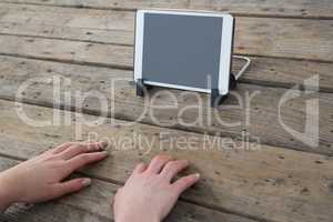 Cropped image of businesswoman typing on invisible keyboard by digital tablet