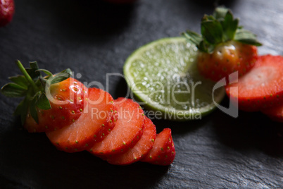 Sliced strawberries and lemon on tray