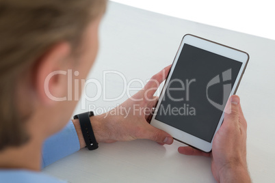 High angle view of businessman using tablet computer at table