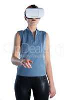Businesswoman gesturing while wearing virtual reality glasses