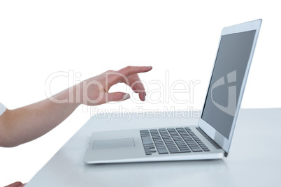 Cropped image of businesswoman gesturing on laptop computer