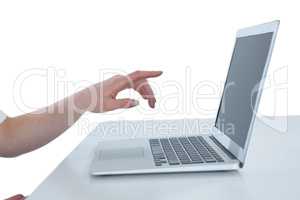 Cropped image of businesswoman gesturing on laptop computer