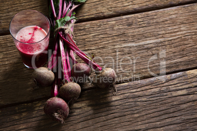 Beetroot and beetroot juice on wooden table