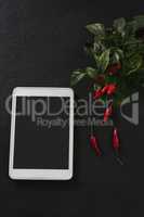 Digital tablet with red chili and leaves