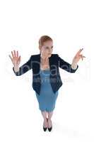 Full length of young businesswoman using imaginary interface