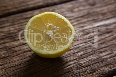 Halved lemon on wooden table