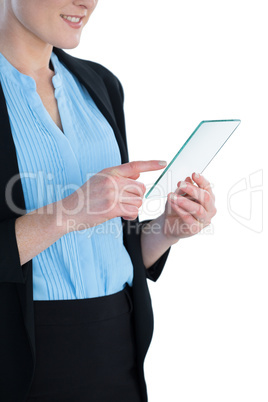 Mid section of smiling businesswoman wearing suit using glass interface