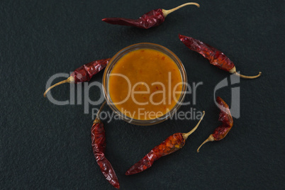 Dried red chili pepper with bowl of sauce