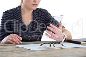 Mid section of businesswoman using transparent glass interface