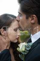 Groom kissing on bride forehead