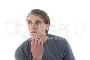 Thoughtful young businessman with hand on chin
