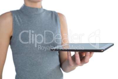 Mid section of businesswoman holding tablet computer