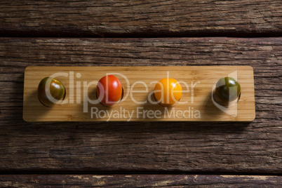 Various tomatoes arrange in wooden tray