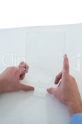 Cropped hands of businessman holding glass interface Cropped hands of businessman holding glass interface