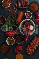 Various spices arranged on black background